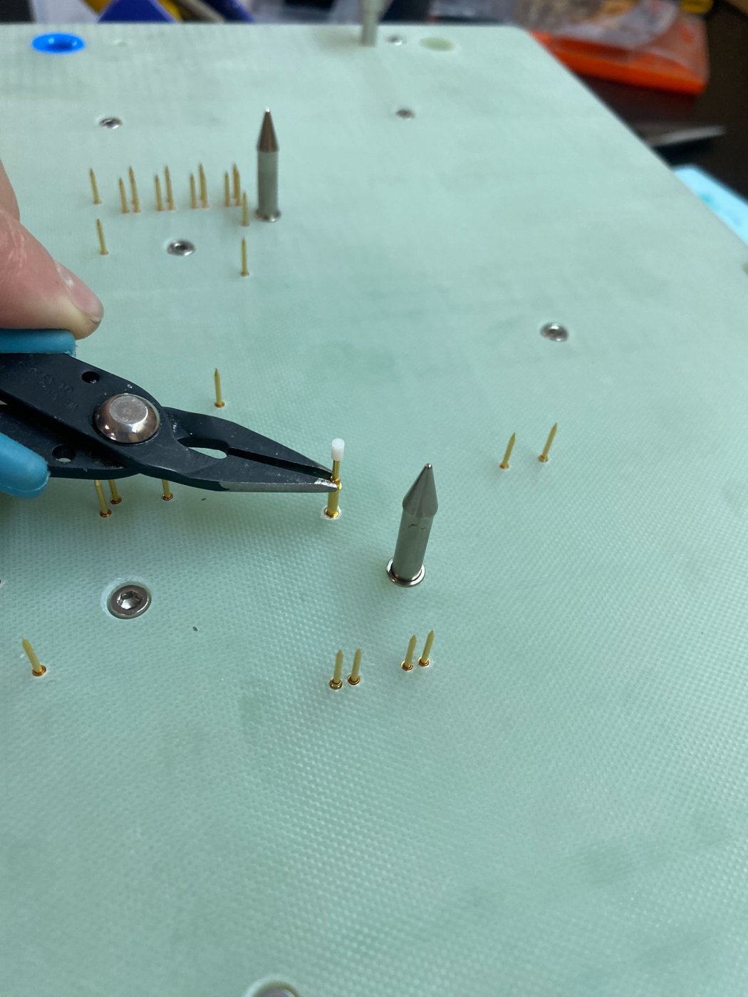Screwing the probe in with needle-nose pliers